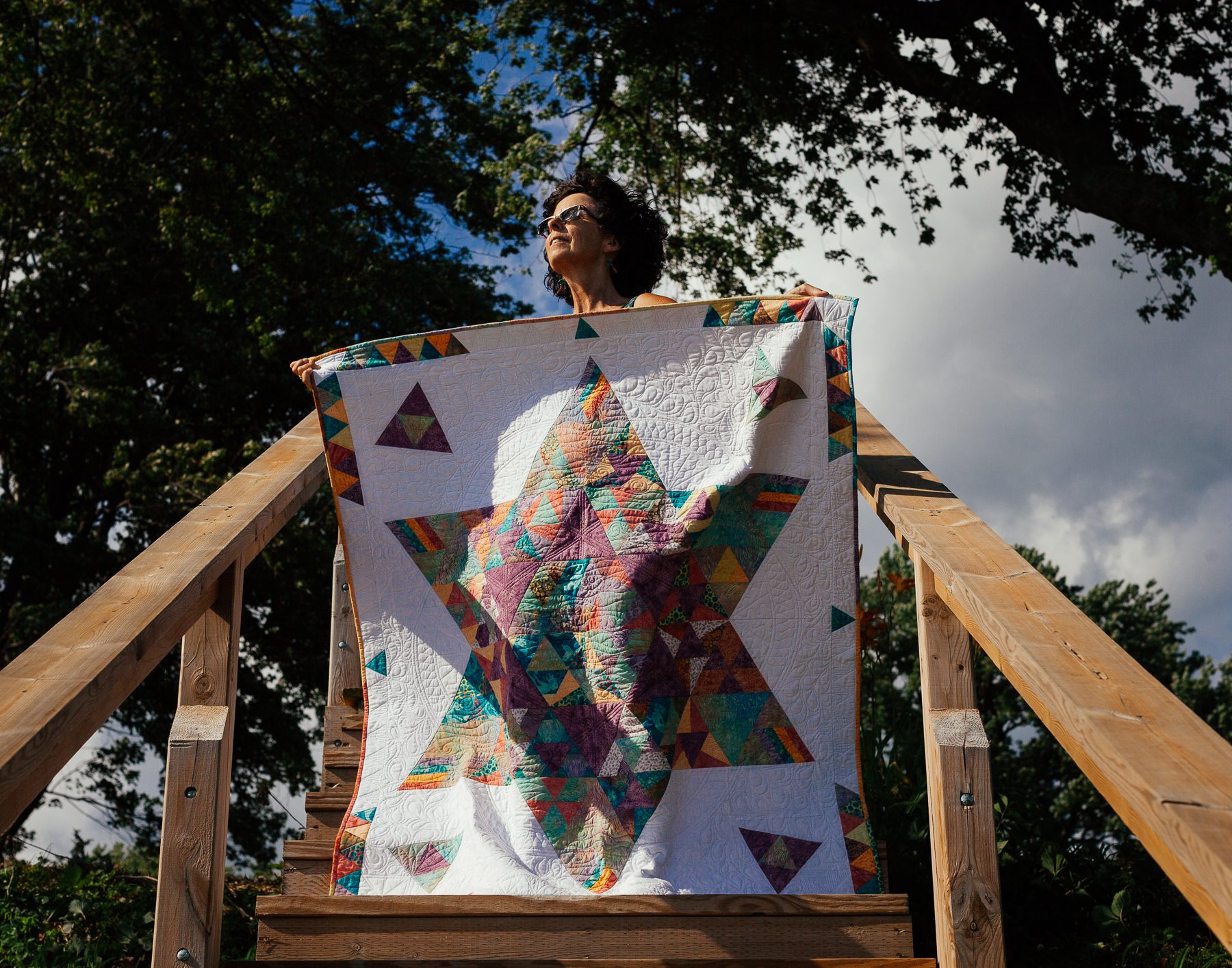 Sandra holds her water-themed quilt of a kelpie’s star. A kelpie is a shape-shifting water spirit who lives in the lochs of Scotland. 