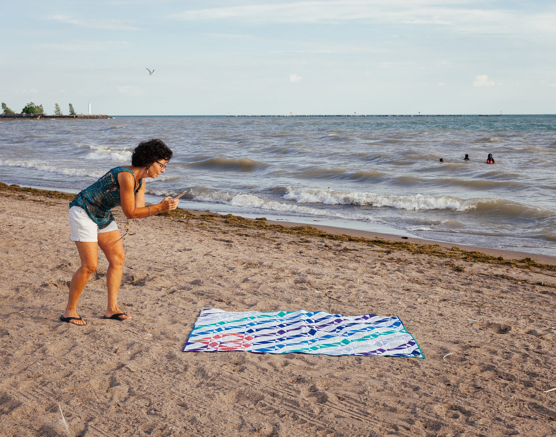 Sandra often photographs her quilts down by the lake for her blog. The name of this particular quilt pattern is “Storm at Sea”.