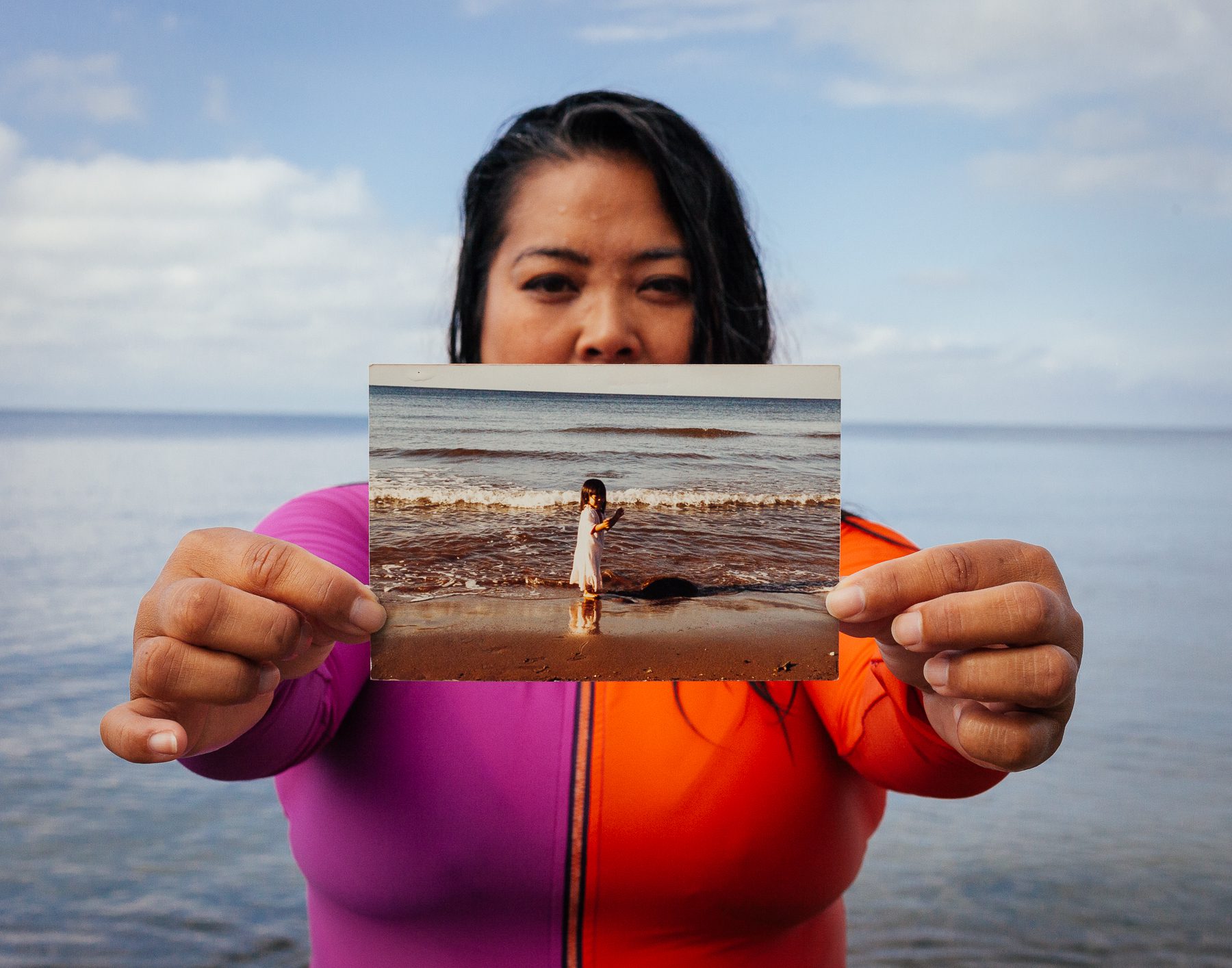 Robin holds a photo of herself at Hawla Beach in Bataan (the province her family is from in the Philippines) on her first visit to the Philippines.