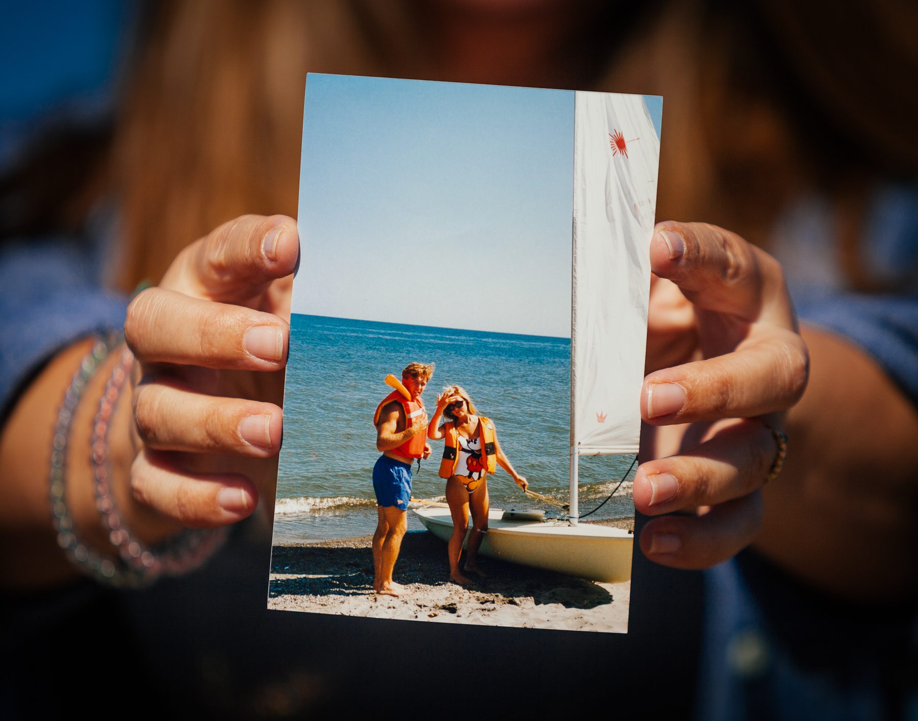 Lisa started dating her husband, Chad, in high school. This photo is of the couple with one of the Laser sailboats. Today they have three sons (Ethan 19, Liam 21, and Ryan 24)  who, like their parents, grew up on the shores of Lake Erie. 